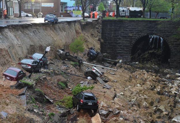 Streetlights, trees and cars have collapsed onto a train track in Baltimore. (Photo by Jonathan Newton / The Washington Post via Getty Images)